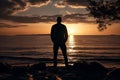 Dusk contemplation Mans silhouette against the Gulf of Finland sunset