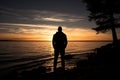 Dusk contemplation Mans silhouette against the Gulf of Finland sunset