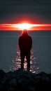 Dusk contemplation Mans silhouette against the Gulf of Finland sunset