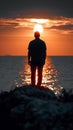 Dusk contemplation Mans silhouette against the Gulf of Finland sunset