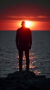 Dusk contemplation Mans silhouette against the Gulf of Finland sunset