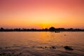 dusk dawn river view sunset orange sky. evening silhouette boat quiet calm chaophraya riverside landscape Royalty Free Stock Photo