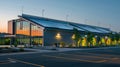 At dusk the factorys solar panels continue to produce clean renewable energy allowing the building to glow with a