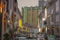 Dusk falls on Keong Saik Road in Singapore during rush hour as busy commuters drive home.