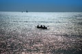 Dusk over sea, fishermen