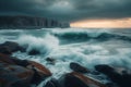 Dusk reveals breaking waves crashing against a rugged, rocky coastline