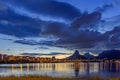 Dusk at Rodrigo de Freitas lagoon with the buildings, hills and lights of the city