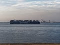 Dusk scene with container ship Evergreen in the estuary of the Scheldt river in Netherlands