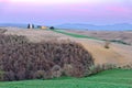 Dusk scenery of a lovely church The Chapel of Our Lady of Vitaleta standing on a grassy hillside with forests in foreground in