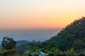 Dusk shot of tree covered hills with beautiful orange sky backdrop