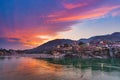 Dusk time at Rishikesh, holy town and travel destination in India. Colorful sky and clouds reflecting over the Ganges River. Royalty Free Stock Photo