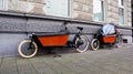 Dusseldorf, Germany - February 20, 2020. A bicycle for mom and baby with a cradle and a child seat for transporting children is