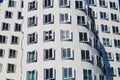 View on white Gehry house facade with futuristic windows facade