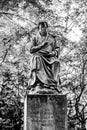 Statue of Maximilian Weyhe 1850 in Reitallee park under gree tree branches in Dusseldorf, North Rhine Westphalia, Germany