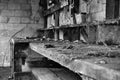 Dust dirt and cobweb covered workbench in an abandoned barn black and white