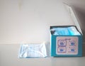 Dust mask to prevent air pollution with paper boxes on a white background