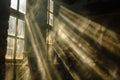 Dust motes suspended in beams of sunlight streaming through a window in an aged structure, Dust motes suspended in beams of light Royalty Free Stock Photo