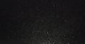 Dust particles fast moving over black background from right Royalty Free Stock Photo