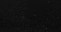 Dust particles fast moving over black background from right Royalty Free Stock Photo