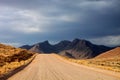 The dust road in the mountainous landscape of central Namibia Royalty Free Stock Photo