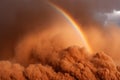 Dust storm creates breathtaking rainbow over desert landscape at sunset Royalty Free Stock Photo
