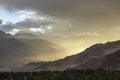 A dust storm in a mountain desert valley during sunset Royalty Free Stock Photo