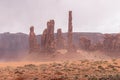 Dust storm sweeping across a desert landscape filled with rock formations. Monument Valle