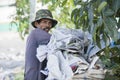 Dustman puts papers in the garbage bag