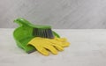 Dustpan and golves in green and yellow Royalty Free Stock Photo