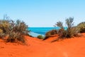 Dusty Australian outback red road and view of the lagoon Royalty Free Stock Photo