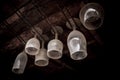 Dusty bar glasses hung upside down.