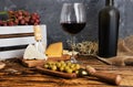 Dusty bottle of red wine on a wooden table