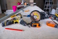 Dusty construction tools lie on a white table covered in dust. Construction.Repairs Royalty Free Stock Photo