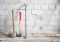 Dusty construction tools near white brick wall Royalty Free Stock Photo