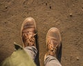 Dusty deserted army boots on the ground at sunset Royalty Free Stock Photo