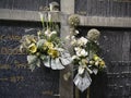 Dusty fake flowers on old grave stones