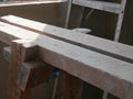 A dusty grungy wooden stand for a construction worker to stand on for concrete wall plastering and paintingl