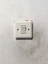 dusty old light switch on white wall Royalty Free Stock Photo