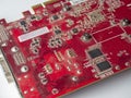 Dusty printed circuit Board with red chips. Old video card Royalty Free Stock Photo