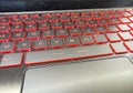 Dusty, static dust covered modern laptop gaming keyboard with red led backlight