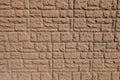 Dusty surface of brown brick veneer wall with random layout