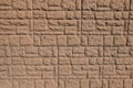 Dusty surface of brown brick veneer wall with random layout Royalty Free Stock Photo
