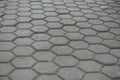 Dusty surface of gray concrete pavement with honeycomb pattern