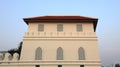 dusty white ancient building facade with beautiful gray wooden windows