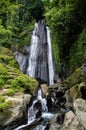 Dusun Kuning waterfall in Bali with woman Royalty Free Stock Photo