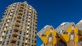 Dutch architecture. Piet Blom`s cube houses kubuswoningen and Blaaktoren Het Potlood, or Pencil tower in one image. Blue sky a