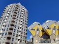 Dutch architecture. Piet Blom`s cube houses kubuswoningen and Blaaktoren Het Potlood, or Pencil tower in one image. Blue sky