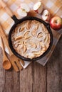 Dutch baby pancake with apples in a pan. vertical top view