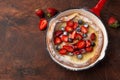 Dutch baby pancake with fresh berry in red pan for breakfast Royalty Free Stock Photo