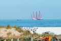 Dutch beach cafe with heavy industry barge off the coast Royalty Free Stock Photo